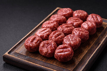 Raw meatballs of minced meat beef, pork or chicken with salt, spices