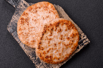Grilled chicken burger cutlet with salt, spices and herbs