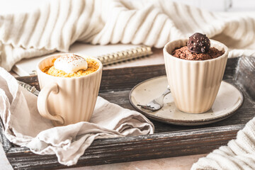 Pumpkin spice and Chocolate mug cake on creamy white background
