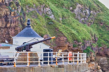 promenade with cannon on cliff in Whitby - North Yorkshire - united kingdom
