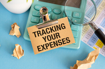 Expense Tracking. Analyzing Expenses with Retro Calculator and Papers on Blue Background