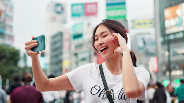 Happy, asian woman and selfie with emoji in city for photography, memory or picture in Tokyo. Japanese, female person or vlog with smile or peace sign for capture, moment or travel in an urban town