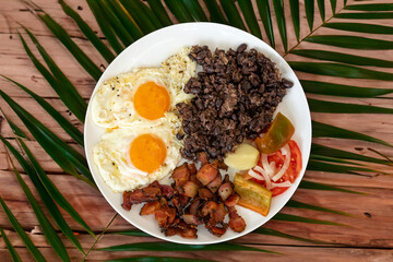 Traditional Brazilian everyday food, black bean stew, bacon, egg, salad, pickles. Real rustic food