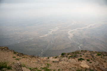 Jebel Samhan, the highest peak in Oman, is a majestic mountain offering panoramic views of rugged cliffs, deep valleys, and the vast desert below.