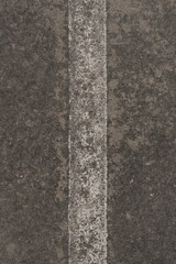 Fototapeta premium Texture, background is a road with a white line in the middle. The road is old. Graphic resources