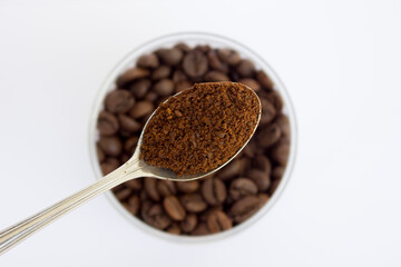 Ground coffee and roasted coffee beans robusta strong blend on white background.