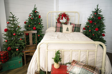 decorated christmas tree with vintage bed with christmas plaid and wreath