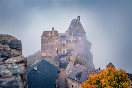 Mistical autmn view of Aggstein Castle. Fabulous morning scene of ancient stone 12th-century castle ruins atop a rocky outcrop offering views of the Danube river. Traveling concept background..