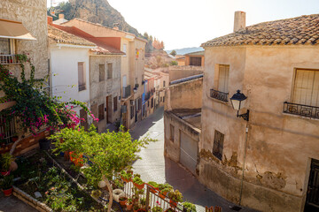 Typical street in the old town of Ricote, Murcia region, Spain, with golden morning light