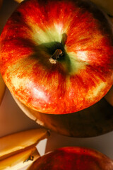 Close-up of vibrant red apples against a matching red background, highlighting their texture, color, and natural freshness in a bold, minimalistic composition