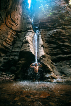 a man in el torno under a waterfall