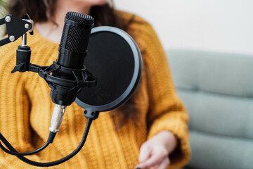 Host woman recording podcast at home studio - Business, podcaster technology. Focus on microphone