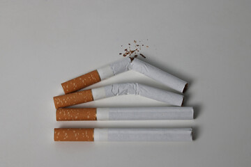 Broken cigarettes on a white background