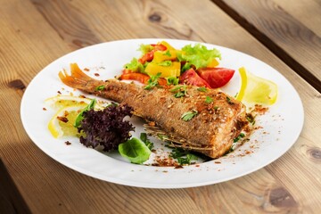 Fried tasty fish steak with cooked gvegetables