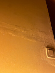 Badly executed wall plastering highlighted by the lightning