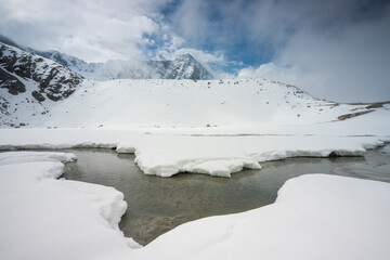 Mountain landscape of snowy winter with peak Adamello and lake Venerocolo in Italian alps, Adamello Park, Lombardy, Italy.