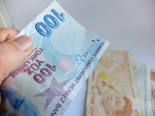 Turkish lira money in hand. Turkish money, closeup of hundreds of Turkish lira banknotes . money...