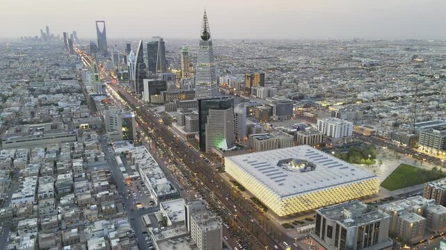 Al Faisaliah Tower. King Fahad National Library. Riyadh. Drone shot flying. Sunset. 