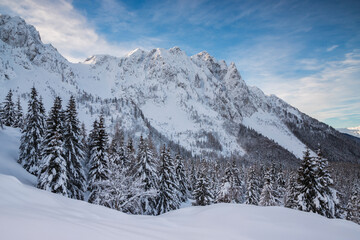 Mountain landscape in snowy winter scenery with soft snow covered trees and peaks by, Orobie alps, Lombardy, Italy