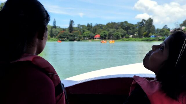 Mother and daughter travelling in motor boat