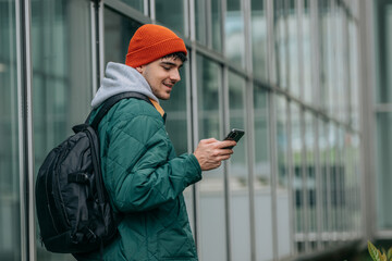 student with backpack and mobile phone