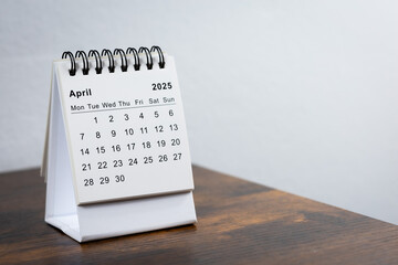 April 2025 calendar on the wooden table. Month page