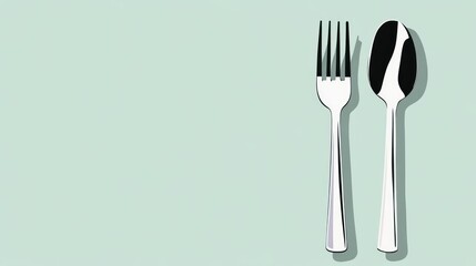 Silver fork and spoon on a light green background