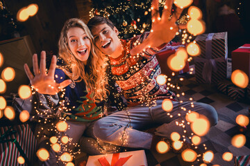 Full size photo of lovely young couple hugging wave hand hello dressed christmas outfit day light home party decoration interior room