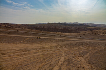 Fototapeta premium Unroad transport as a scourge of nature. The desert has literally been traversed by motorists who drive off-road in jeeps, trampling down. Iran