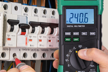Electrician Testing Circuit Breaker with Multimeter