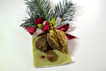 Handmade decoration of fir branches cones nuts acorns patch New Year decoration gift with bow and beads. Composition of natural materials Christmas tree branch pine cone boutonniere snow-covered 
