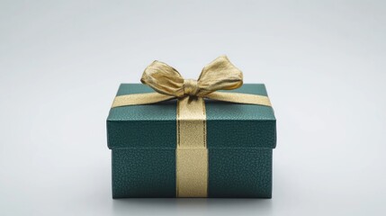 Obraz premium green gift box wrapped with gold bow and ribbon isolated on white background. 