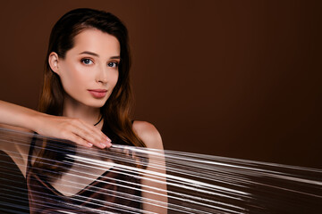Fototapeta premium Photo of gorgeous stunning lady hide over transparent material isolated on brown color background