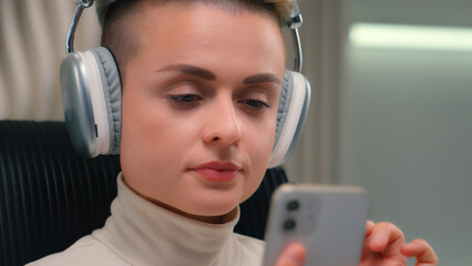 Futuristic fashion woman Caucasian female listen music in headphones close up trendy happy girl...