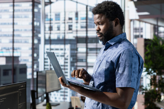 Programmer testing and debugging company software to minimize occurrence of bugs, identifying bottlenecks. Man writing clean, efficient code in programming language to reduce errors