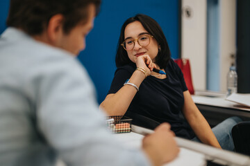 Two students interact during a classroom session, showcasing active engagement and collaborative...