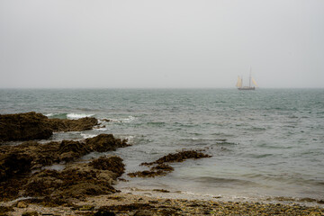 Old ghostly ship or boat sailing along Cornish coast. Pirates and smugglers