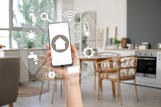 Blurred view of light kitchen with counters and dining table