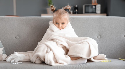 Fototapeta premium Sick little girl with plaid at home