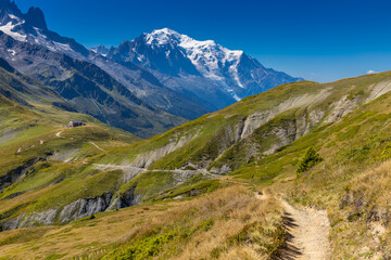 Fototapeta premium Mont Blanc snow summit, the highest peak in Europe, located in the Alps. A stunning landscape featuring snow-covered peaks, rugged terrain, and vast skies, showcasing the majestic beauty of Alps
