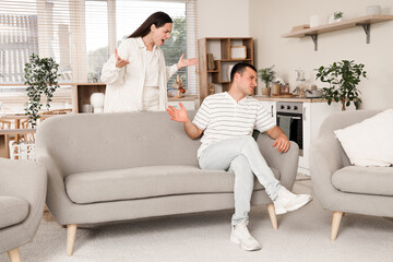 Angry young woman quarreling with her husband at home