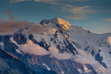 Naklejka premium Mont Blanc snow summit, the highest peak in Europe, located in the Alps. A stunning landscape featuring snow-covered peaks, rugged terrain, and vast skies, showcasing the majestic beauty of Alps