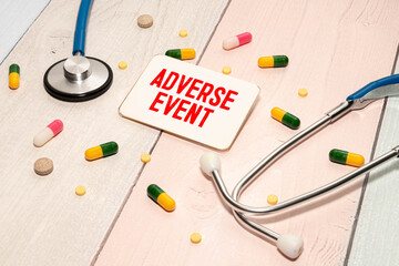 Stethoscope and clipboard with ADVERSE EVENT text on white sheet of paper