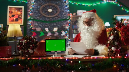 Santa Claus checking his naughty or nice list next to isolated mockup, preparing for his journey...