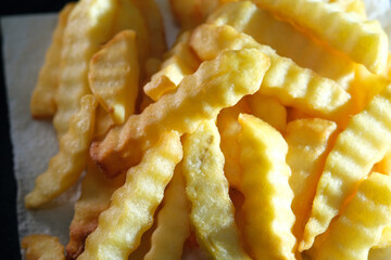 Close up of fried crinkles fries with French sea salt
