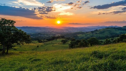 Obraz premium Serene Sunset Over Rolling Hills with Vibrant Colors in the Sky, Captured in High-Resolution Format for Nature and Landscape Photography Enthusiasts