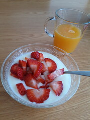 breakfast with Fresh Orange juice and strawberries in yogurt