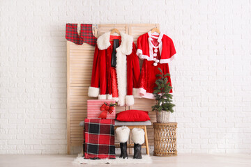 Obraz premium Interior of hall with Santa costumes, folding screen and bench