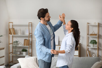 Obraz premium Happy married couple dancing at home