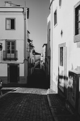 Naklejka premium Narrow cobblestone roads and buildings were built close to fend off the hot sun in historical Portugal towns